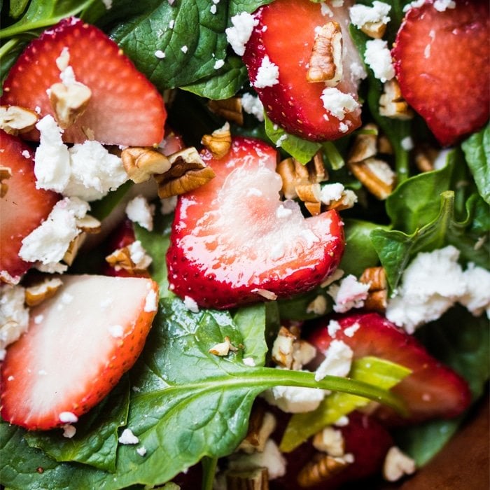 Closeup keto strawberry salad with spinach, basil, pecans and feta