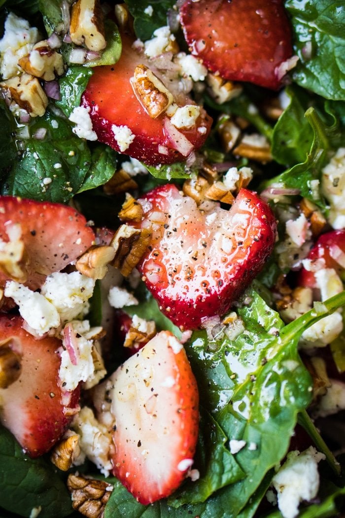 Closeup keto strawberry salad with spinach, basil, pecans and feta