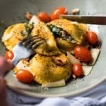 Cutting a keto ravioli with a knife and fork