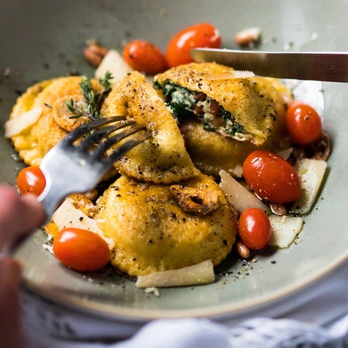 Cutting a keto ravioli with a knife and fork