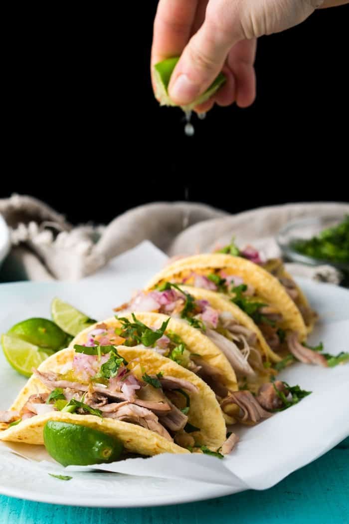Squeezing a lime unto keto carnitas tacos