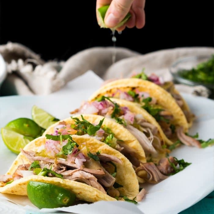 Squeezing a lime unto keto carnitas tacos