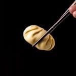 Holding a keto dumpling with chopsticks