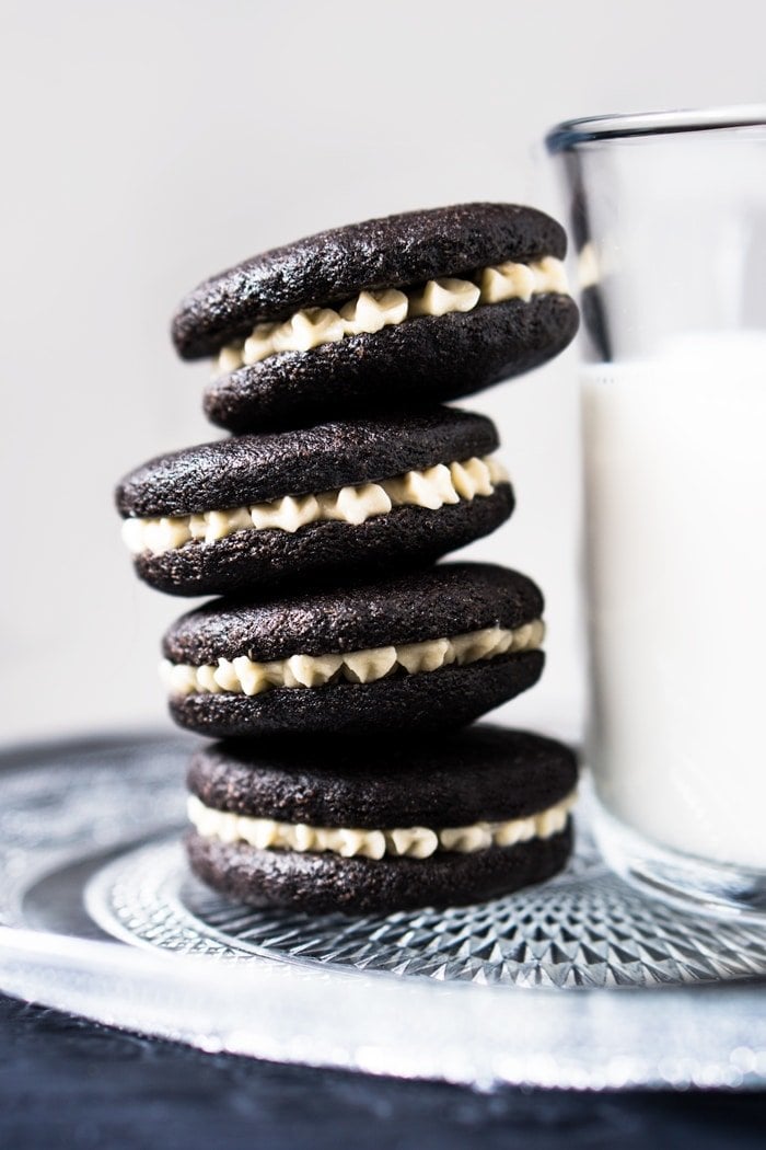 Gluten free & keto oreos stacked with a glass of milk