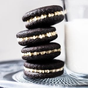 Gluten free & keto oreos stacked with a glass of milk