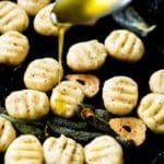Drizzling olive oil onto keto ricotta gnocchi