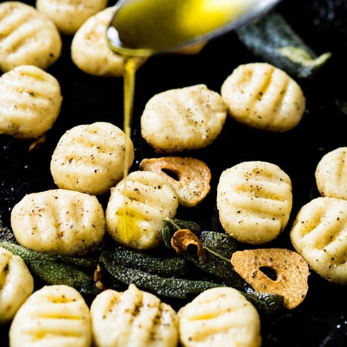 Drizzling olive oil onto keto ricotta gnocchi