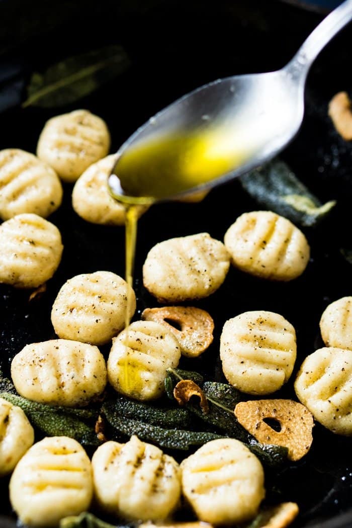 Drizzling olive oil onto keto ricotta gnocchi