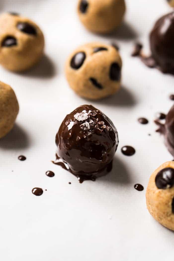Dipping keto cookie dough in melted chocolate