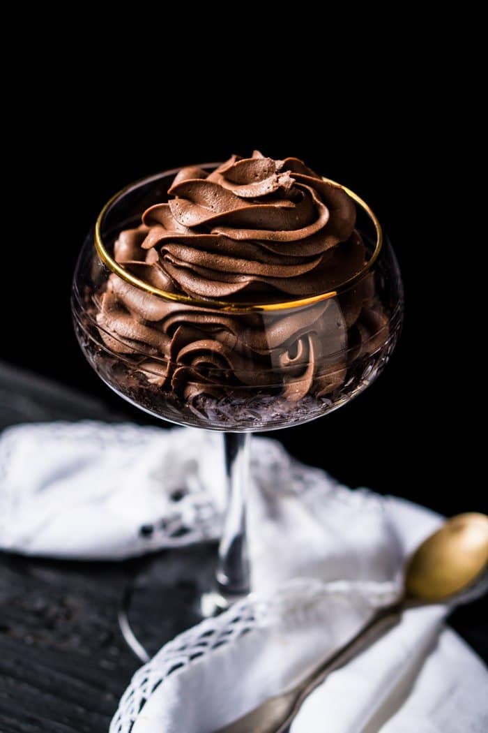 A gluten free & keto chocolate cheesecake with a white napkin and spoon