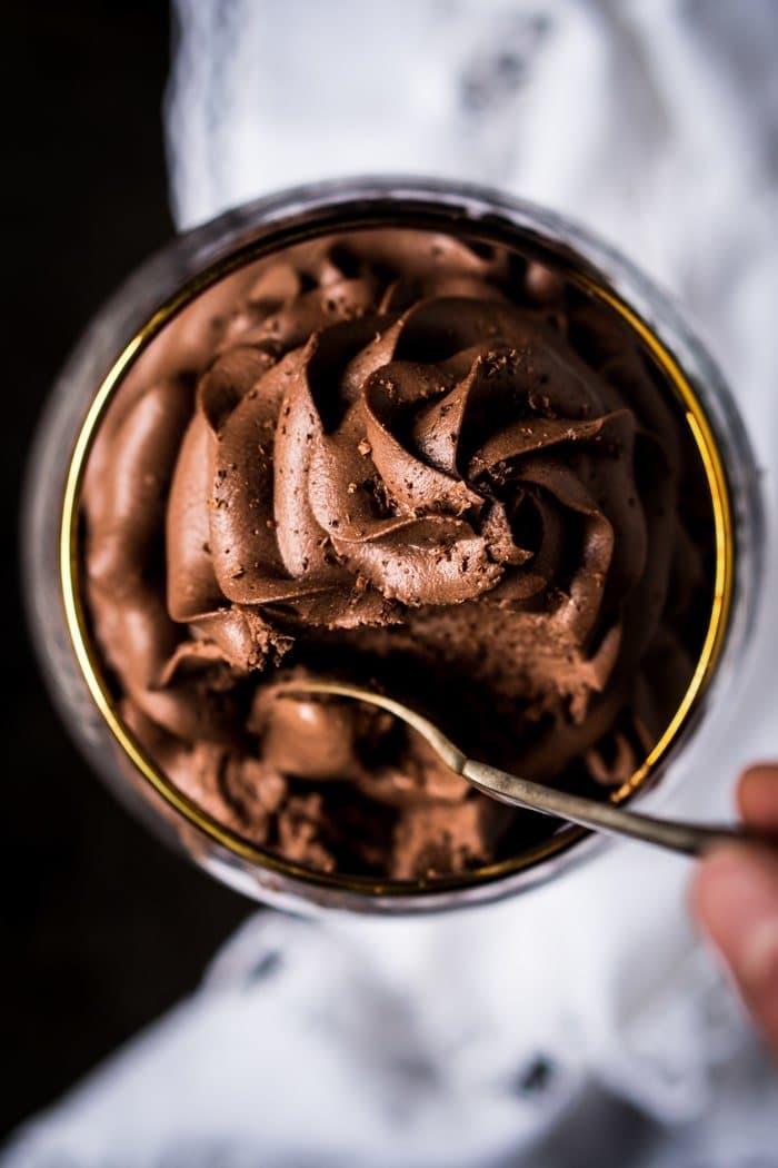 Taking a spoonful of keto chocolate cheesecake