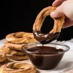 Dipping a keto churro donut in chocolate sauce