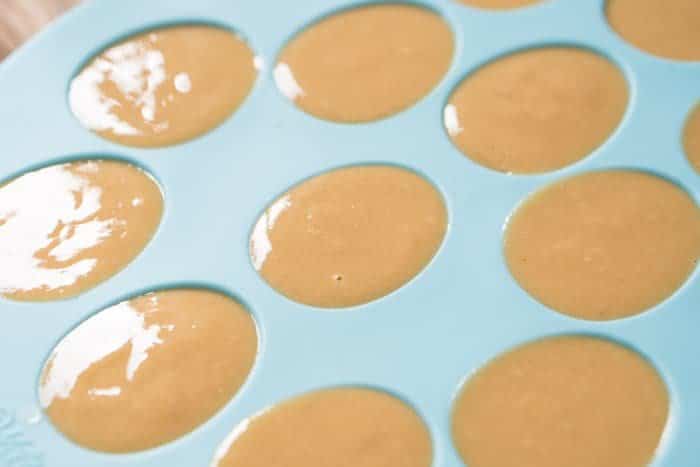 Making keto chocolate peanut butter easter eggs in a blue silicon mold