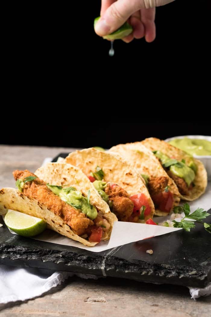 Squeezing a lime onto Keto fish tacos