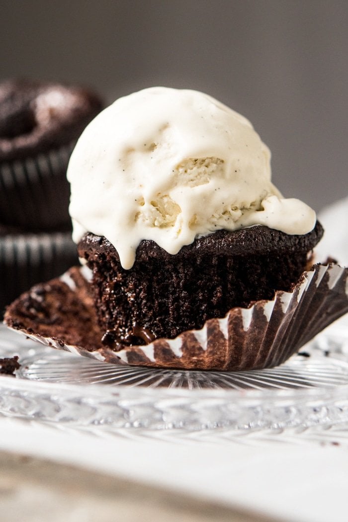 Keto chocolate muffin topped with a scoop of vanilla ice cream