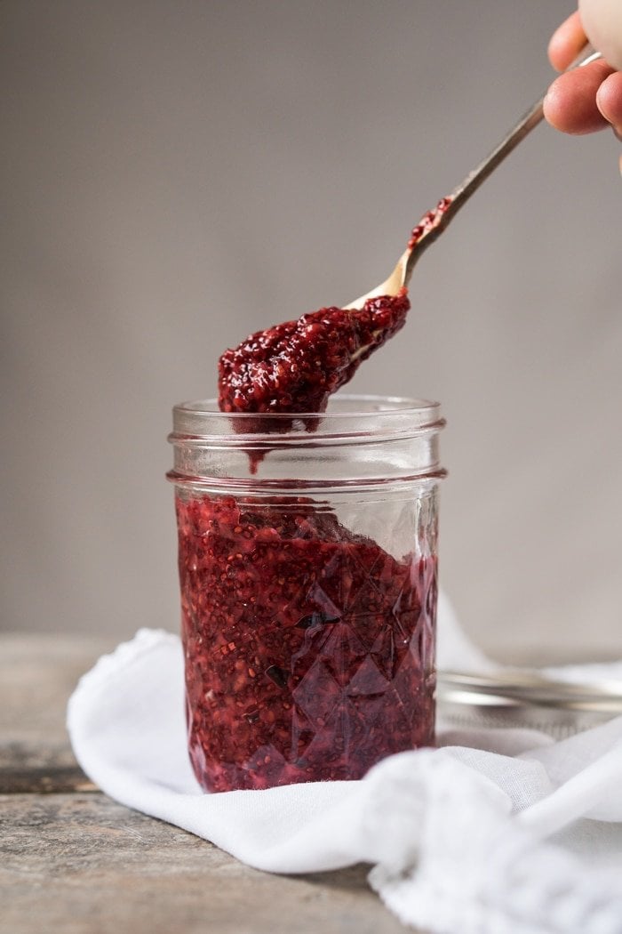Taking a spoonful of keto raspberry chia jam