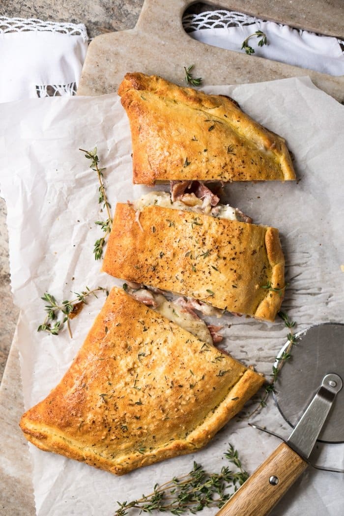 Slicing up a keto calzone with a pizza cutter