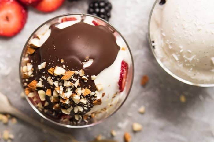 Overhead shot of keto frozen yogurt with magic chocolate shell and nuts