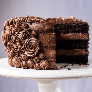 Sliced paleo & keto chocolate cake with cream cheese buttercream frosting