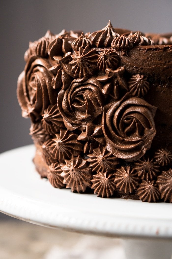 Closeup of chocolate buttercream flowers on a keto chocolate cake