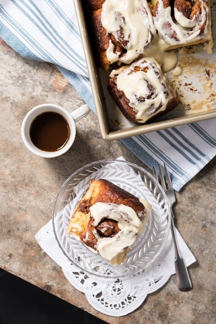 A keto cinnamon roll on a plate with coffee on the side