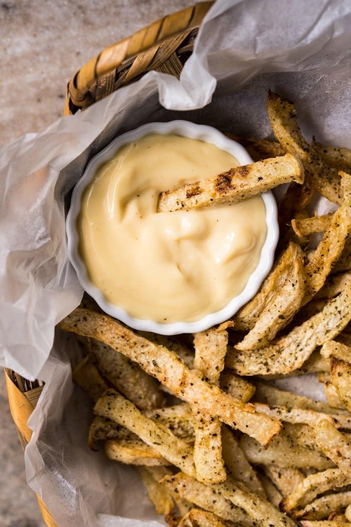 Dipping a keto jicama fry in mayonnaise