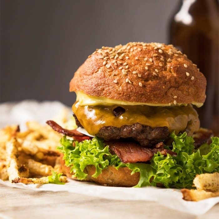 Keto burger buns with a beef paddy, American cheese, lettuce and bacon