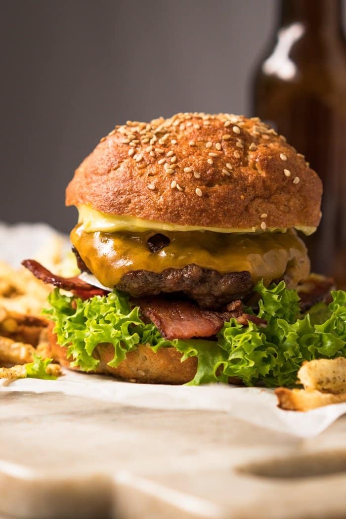 Keto burger buns with a beef paddy, American cheese, lettuce and bacon