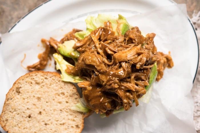 Overhead shot assembling a keto BBQ pulled pork sandwich