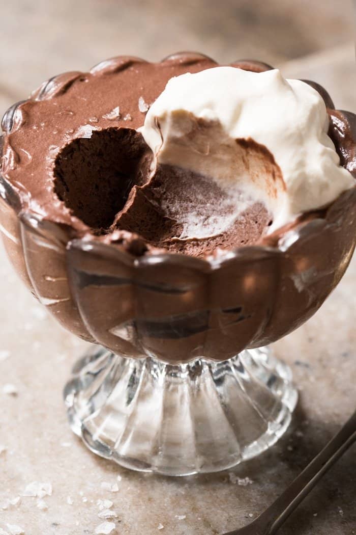 Keto chocolate mousse with whipped cream in a serving glass