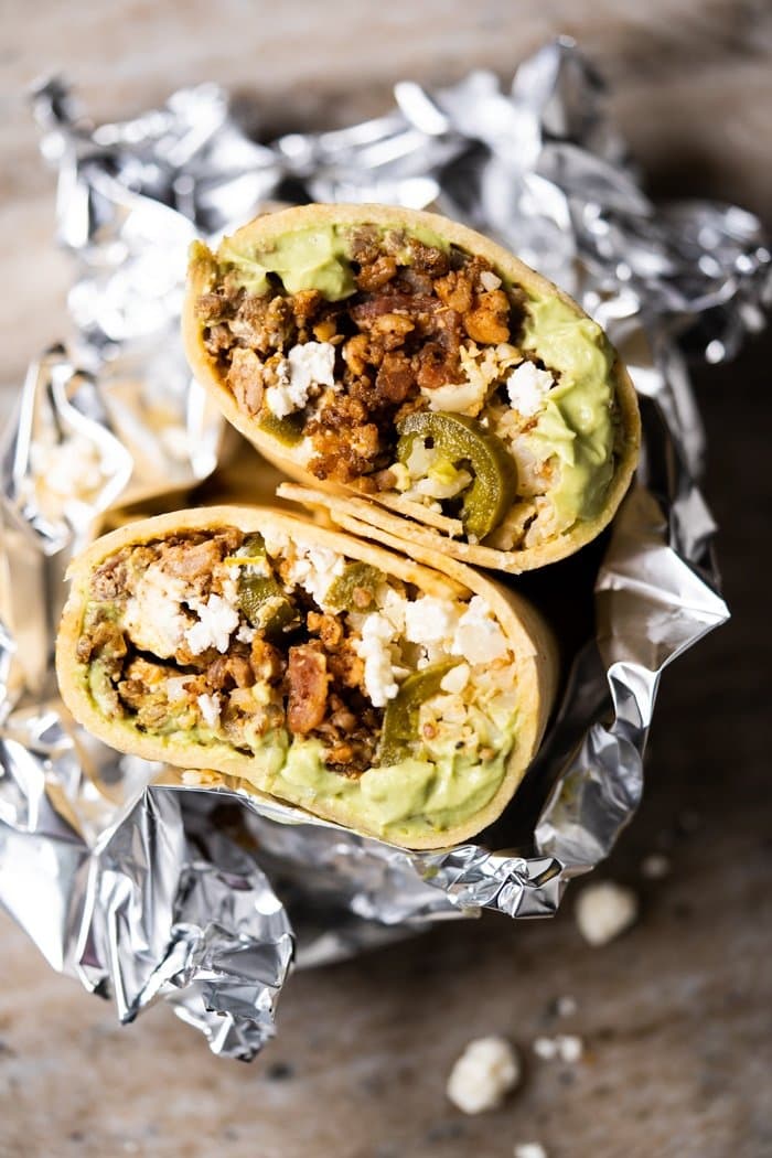 Keto beef burritos cut in half, wrapped in foil