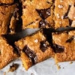 Sliced keto peanut butter blondies with chocolate chunks and flakey sea salt