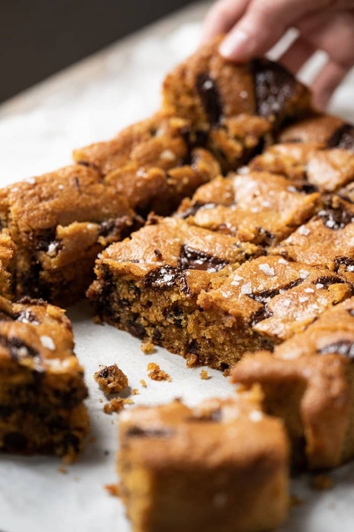 Hand taking a keto peanut butter blondie