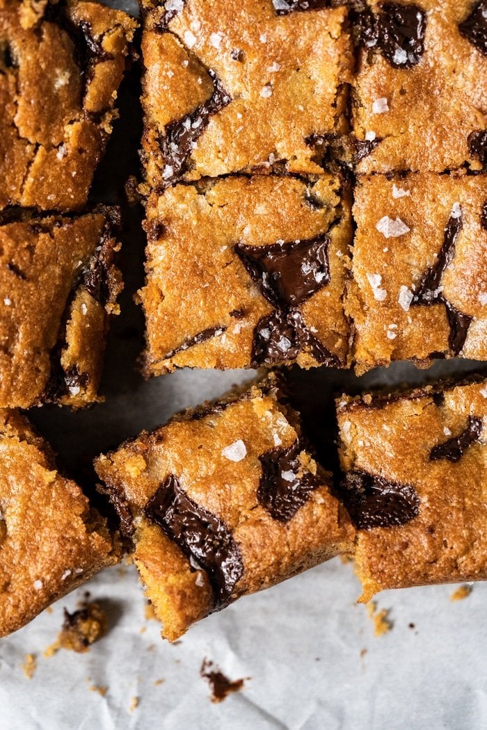 Sliced keto peanut butter blondies with chocolate chunks and flakey sea salt