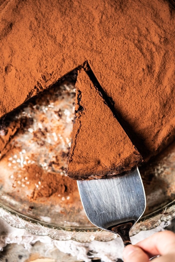 Taking a slice of flourless chocolate cake