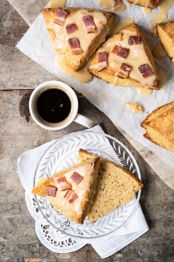 Sliced keto maple bacon scone on a glass plate served with coffee