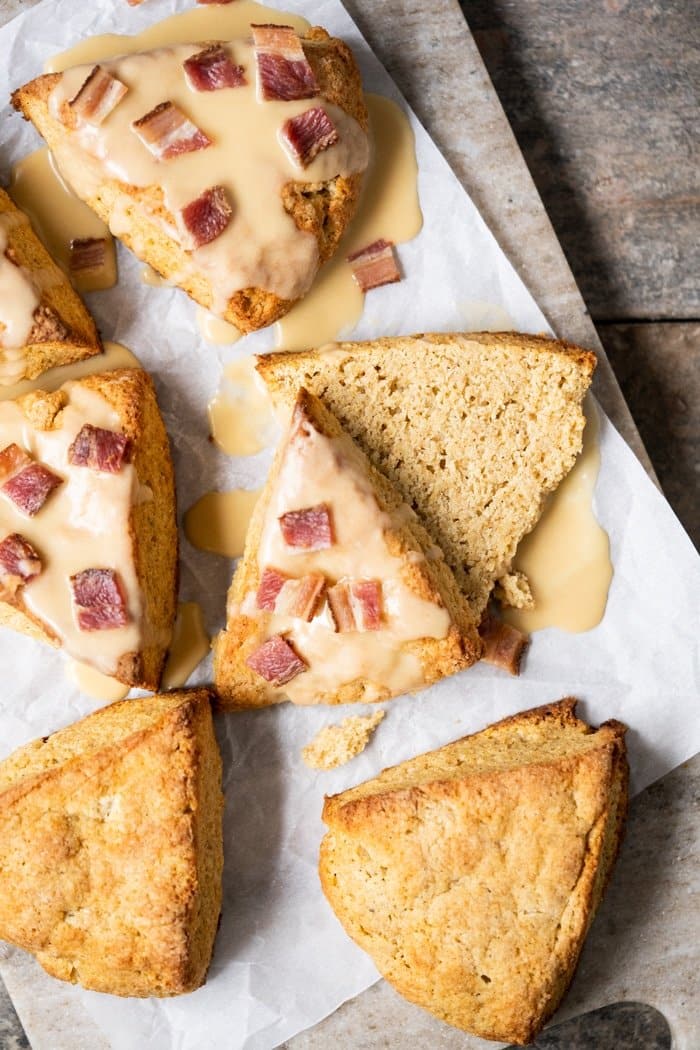 Sliced keto maple bacon scone, surrounded by more scones