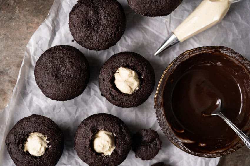 Filling keto chocolate cupcakes with vanilla cream