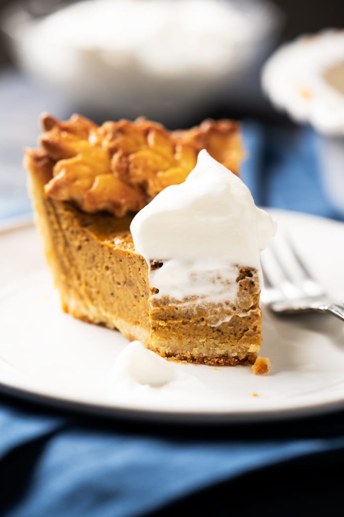 Eaten slice of keto pumpkin pie with smeared whipped cream