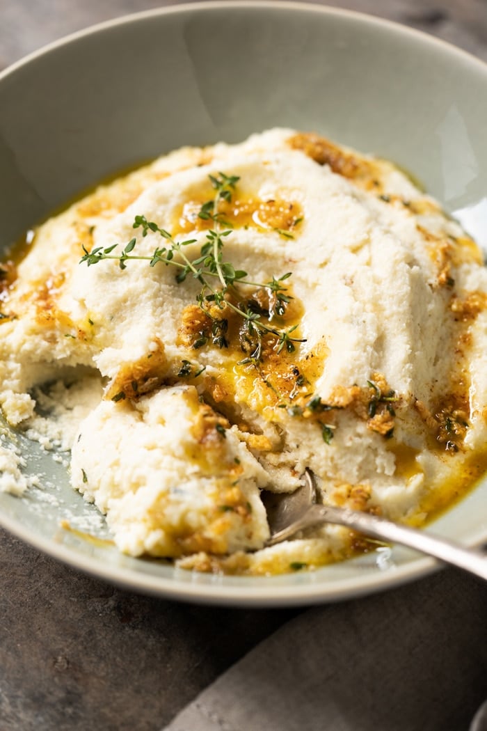 Keto cauliflower mash with a serving spoon