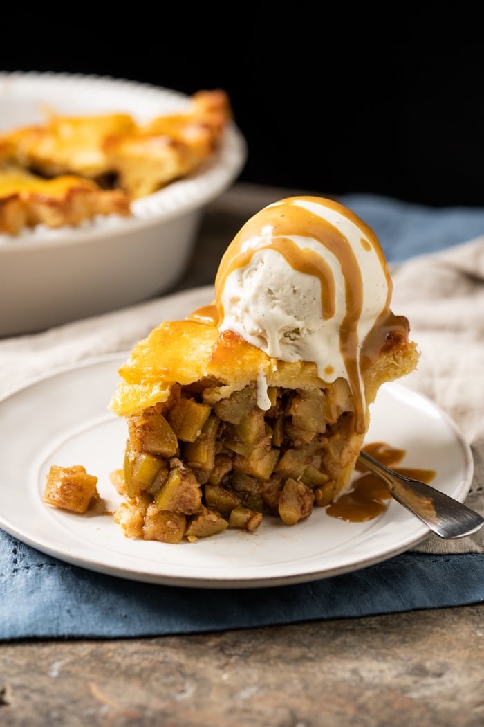 A slice of keto apple pie with vanilla ice cream and caramel