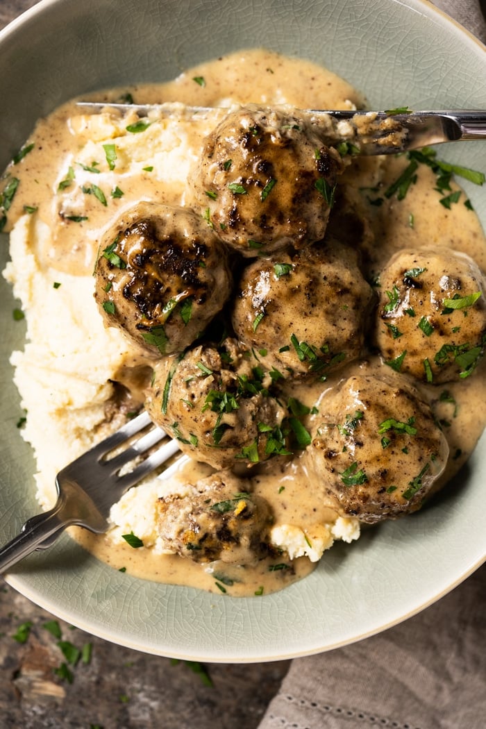 Keto Swedish meatballs over a bed of mashed cauliflower