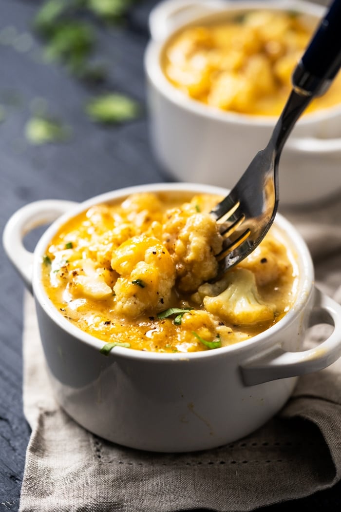 Eating keto cauliflower mac and cheese with a fork
