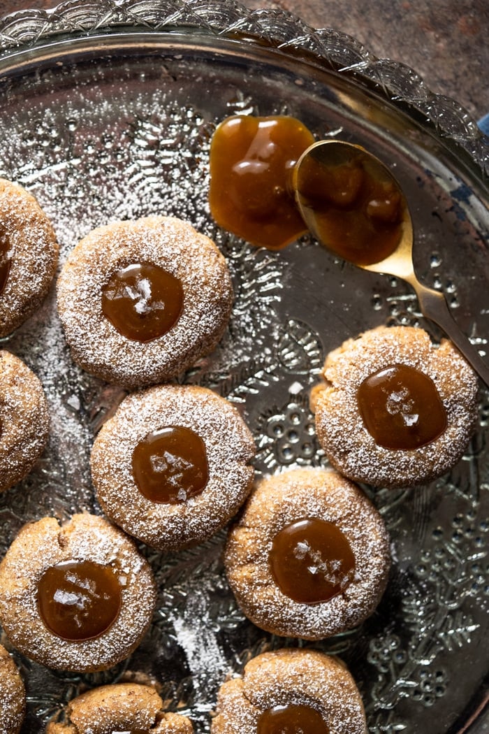 Keto thumbprint cookies with a dripping salted caramel spoon