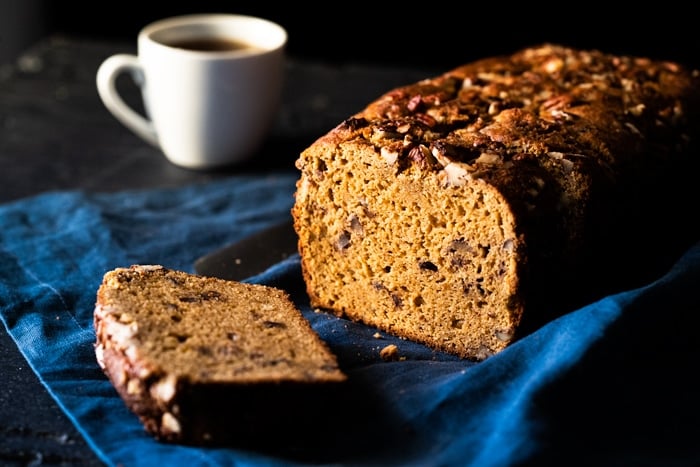 A sliced keto banana bread with a cup of coffee