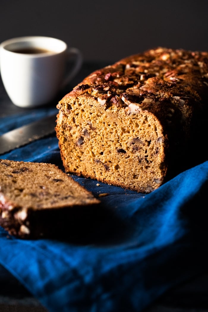 A sliced keto banana bread with a cup of coffee