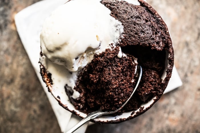 Paleo & keto mug cake with a spoon and vanilla ice cream