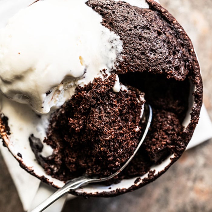 Paleo & keto mug cake with a spoon and vanilla ice cream