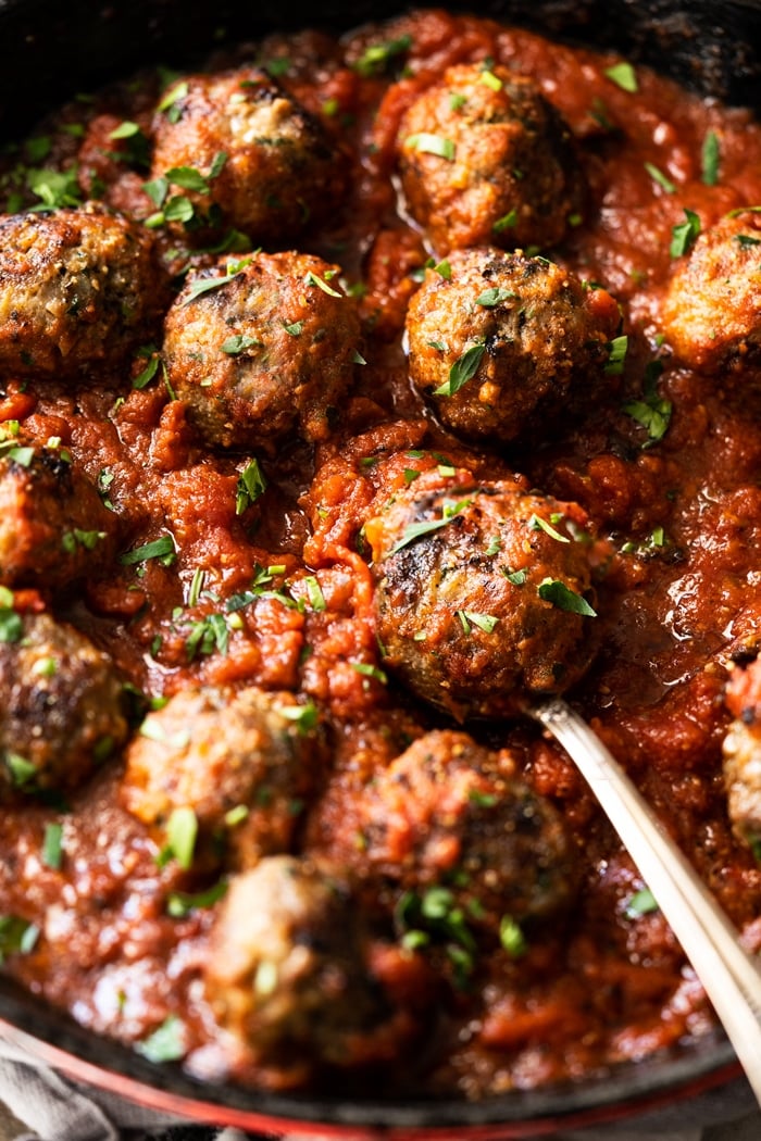 Serving keto meatballs with marinara and fresh parsley