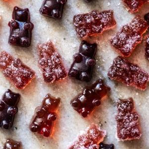 Overhead shot of sour and raspberry keto gummies on marble